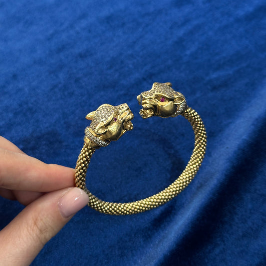 Bracciale pantera anni '60 in oro giallo, diamanti e rubini